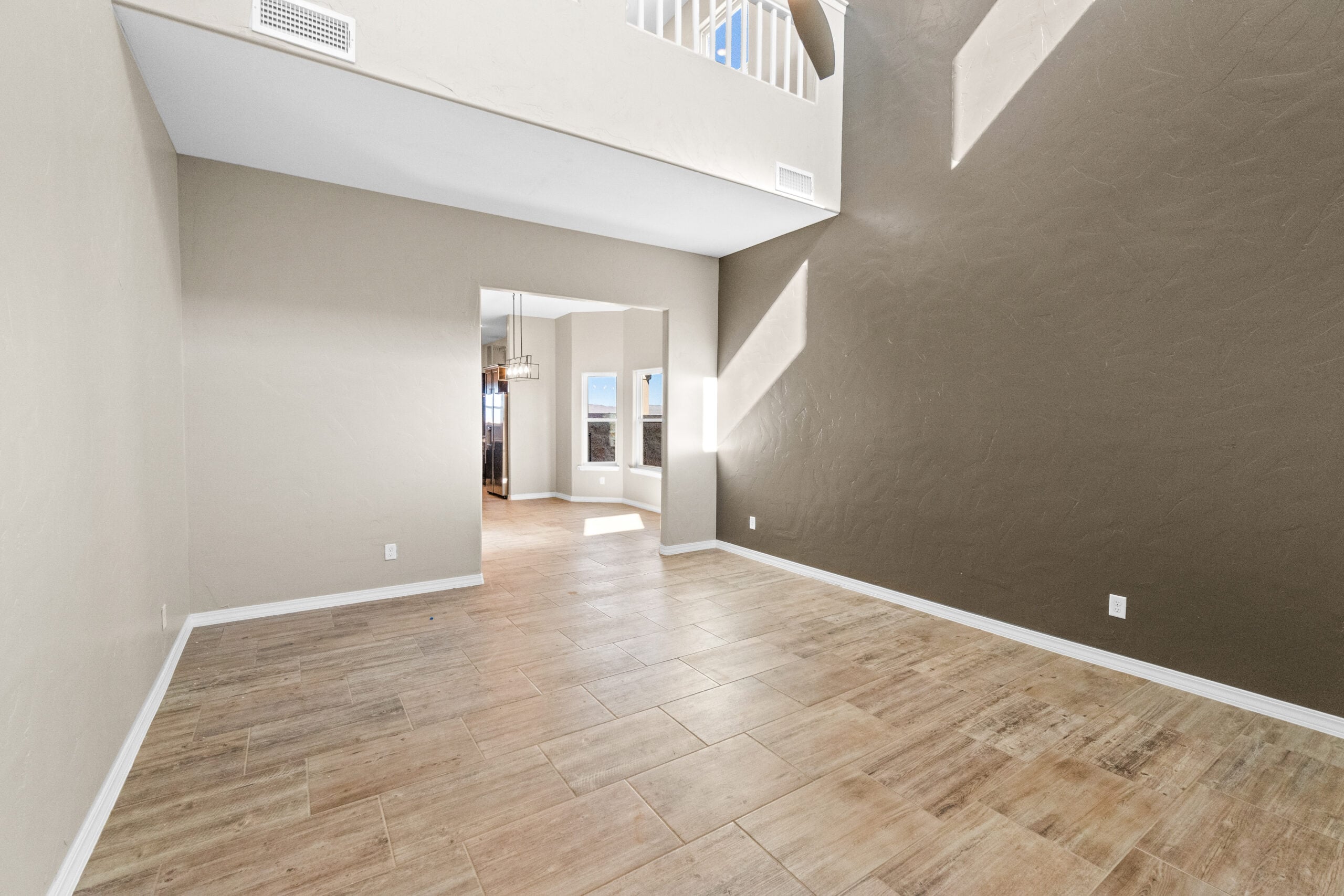 View of The Trellis model's spacious living room with vaulted ceilings and natural lighting.