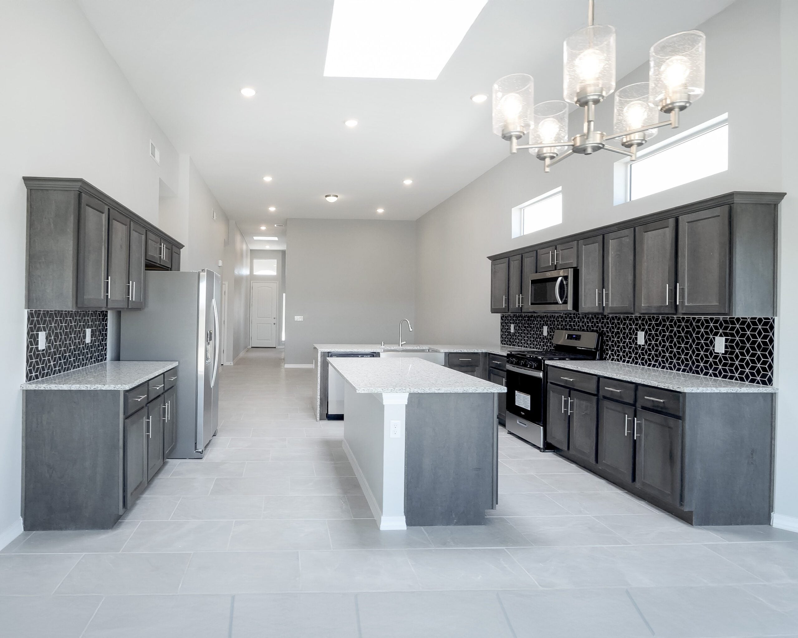 The Lotus kitchen with a floating island and counter space / cabinet storage on each side of the room.
