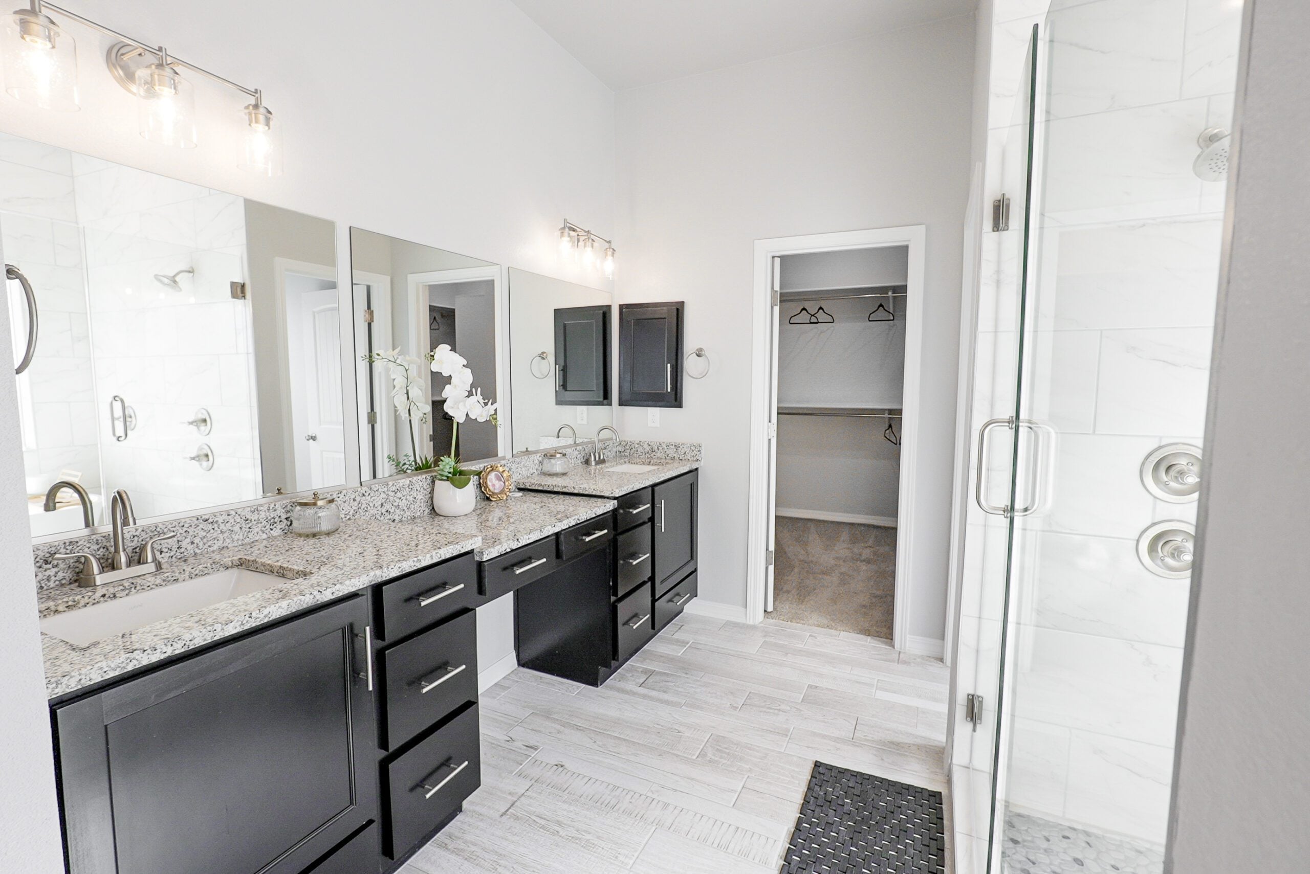 The Orchid Bathroom with large mirror and two sinks. great lighting and open space.