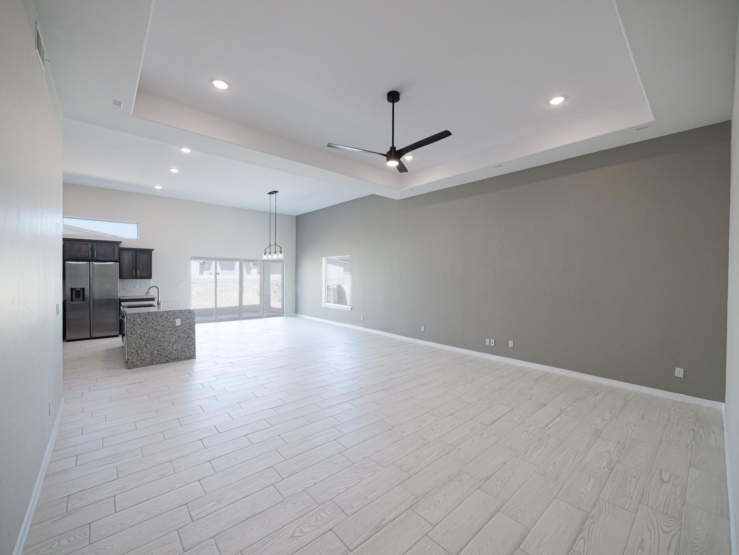 Hibiscus living area with an open space connecting kitchen, dining, and living room.