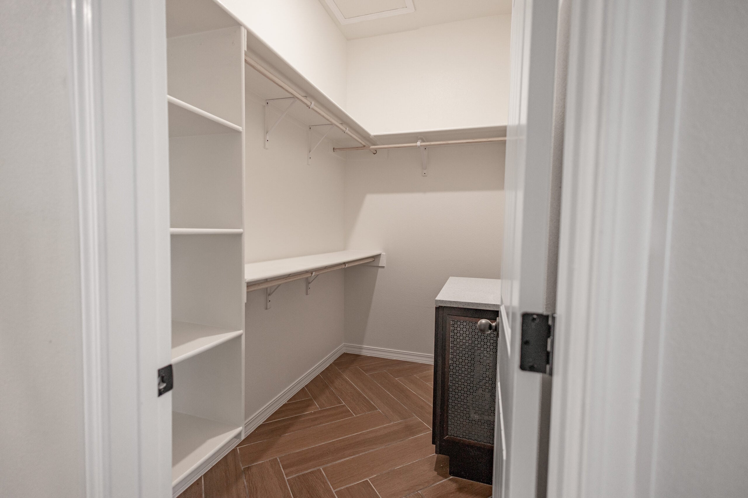 The Daisy Master Closet with a small island and shelving.